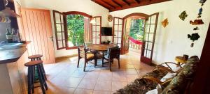 a living room with a table and a couch at Residencial Vitoria "Pé na Areia" in Ubatuba