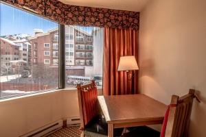a dining room with a table and a large window at Grand Lodge Condo in the Heart of Mt Crested Butte condo in Crested Butte