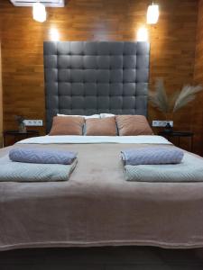a large bed with two pillows on top of it at Sweet Home in Kyiv
