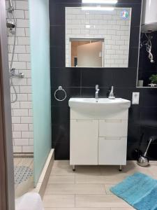 a bathroom with a white sink and a mirror at Sweet Home in Kyiv