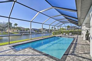 an indoor swimming pool with an awning on a house at Sun-Seekers Getaway Lavish Cape Coral Villa in Cape Coral