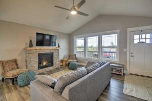 a living room with a couch and a fireplace at Modern Ocean Shores Home, 2 Mi to Beach! in Ocean Shores