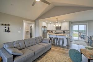 a living room with a couch and a kitchen at Modern Ocean Shores Home, 2 Mi to Beach! in Ocean Shores