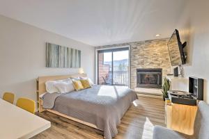 a bedroom with a bed and a fireplace at Modern Frisco Studio Walk to Main Street! in Frisco