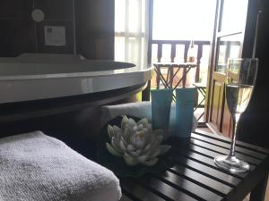 a table with a plant and a glass of wine at La Casa de Noelia in Hinojedo