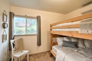 a bedroom with a bunk bed and a chair and a window at Family Home Near Kings and Sequoia National Parks! in Squaw Valley
