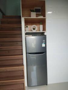 a refrigerator in a kitchen next to some stairs at บ้านขวัญกมล in Chiang Khan