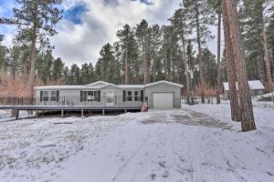 a house in the woods in the snow at 14 A Getaway Family House with Large Deck! in Sturgis