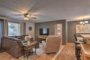 a living room with a couch and a table at 14 A Getaway Family House with Large Deck! in Sturgis