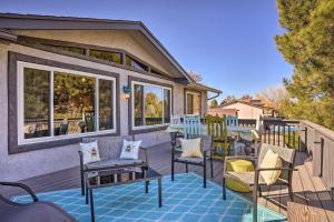 a deck with chairs and tables on a house at Colorful Cottonwood Home Walk to Verde River! in Cottonwood