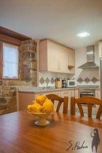 a kitchen with a table with a bowl of fruit on it at Casa Jauregui in Ibilcieta