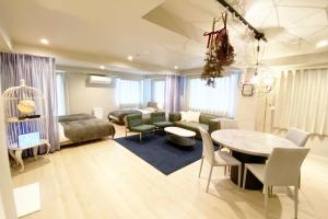 a living room with a table and a dining room at RESIDENCE HARIMAYA-Vacation STAY 99863v in Kochi