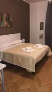 Un dormitorio con una cama con dos toallas encima. en MyRoom CenterStation Bologna, en Bolonia