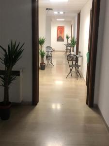 a hallway with chairs and tables in a building at MyRoom CenterStation Bologna in Bologna