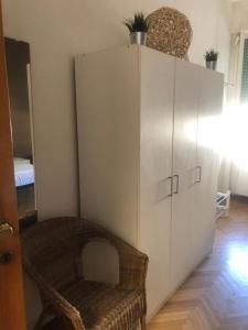 a large white cabinet with a chair in a room at MyRoom CenterStation Bologna in Bologna