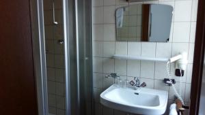 a bathroom with a sink and a mirror at Gästehaus Maschler in Sankt Anton am Arlberg