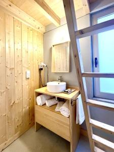 a bathroom with a sink and a mirror at Aloia Nature, Alojamiento Forestal in Tui