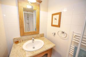 a bathroom with a sink and a mirror and a shower at Le Refuge du Montagnard, Arc 1950, Skis aux pieds, Spa in Arc 1950