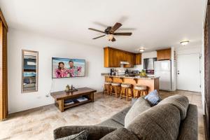 a living room with a couch and a kitchen at Kailua Village#307 in Kailua-Kona