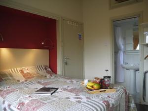 a bed with a tray of fruit on it at Rodeen self-catering apartment in Castletownbere