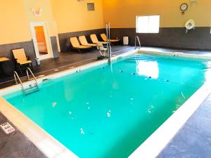 a large swimming pool with blue water at Holiday Inn Express & Suites Smithfield - Providence, an IHG Hotel in Smithfield