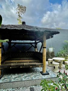 a wooden bench with a view of the water at Gerbera 4BR Villa Springhill Garden Malang in Malang