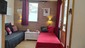 a small room with a bed and a window at PARADISKI-BELLE PLAGNE, Altitude 2050m, APPART skis aux pieds 4 personnes in La Plagne Tarentaise