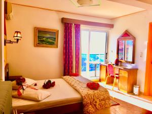 a room with a bed with flowers on it at delphi aiolos center hotel panoramic view&yoga harmony hotel&rooms in Delphi