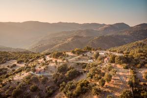 an aerial view of a village in the mountains at Toumba Eco Farm Guesthouses in Plomarion