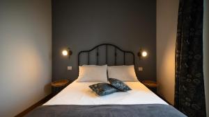a bedroom with a large bed with two pillows on it at La Mascarana in Lesa