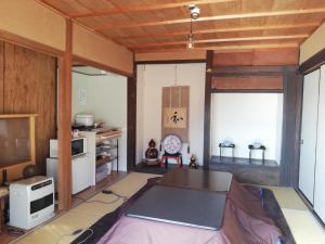 a living room with a table and a tv at Tsukechi Bachanchi - Vacation STAY 89810v in Nakatsugawa