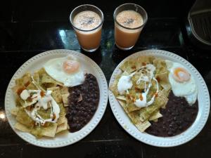 two plates of food on a table at Casa del Arquitecto in Cancún
