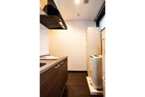 a small kitchen with a sink and a refrigerator at Apartment Sun Bright - Vacation STAY 89260v in Tokyo