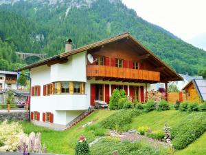 a house on top of a hill with a mountain at Haus Wallner in Klösterle am Arlberg