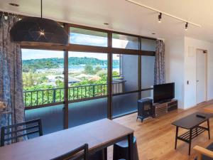 a living room with a large window with a view at n-house - Vacation STAY 91411v in Nago