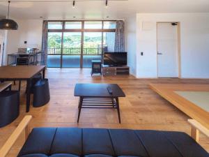 a living room with a couch and a table at n-house - Vacation STAY 91411v in Nago