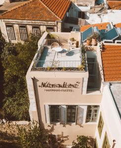 a building with a sign for the meritage restaurant suites at Neratze Hammam Suites in Rethymno