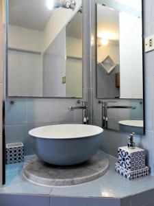 a bathroom with a large tub and a mirror at La Mole apartment in Turin