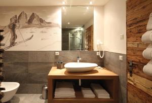 a bathroom with a sink and a mirror at Naturapartments Schönfeld in Sesto +47 photos