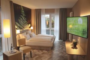 um quarto de hotel com uma cama e uma televisão de ecrã plano em Thöles*** Hotel in Vilsen em Bruchhausen-Vilsen