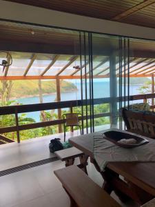 ein Zimmer mit Tisch und Blick auf das Meer in der Unterkunft Casa praia vista mar ttg in Toque Toque Grande