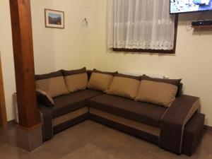 a couch in a living room with a tv at Chalupa pri Uličke - Terchová centrum in Terchová