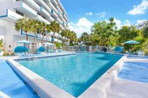 a swimming pool in front of a building at Chateau Mar Golf Resort, Trademark Collection by Wyndham in Lauderhill