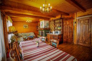 a living room with a table and a couch at Country house Domik v derevne in Markovtsy