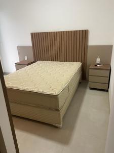 a bedroom with a bed and two night stands at DNA UBATUBA in Ubatuba +21 photos
