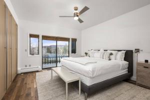 a bedroom with a large bed and a ceiling fan at Snowmass 3 Bedroom Private Hot Tub in Snowmass Village