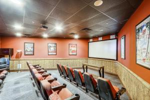 a lecture room with orange walls and a screen at Origin at Seahaven #831 by Book That Condo in Panama City Beach +72 photos