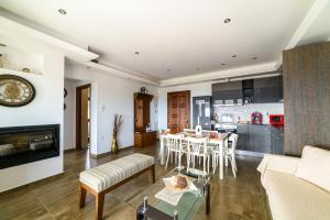 a living room and kitchen with a table and a couch at Mansion Chalatsopoulos in Volos