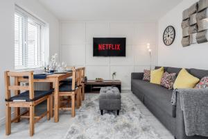a living room with a couch and a dining room table at Dartford Kent Smart Nest in Dartford