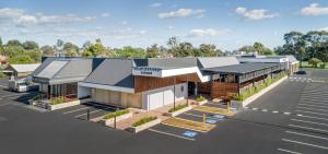 a building with a parking lot in front of it at Blacktown Tavern in Blacktown